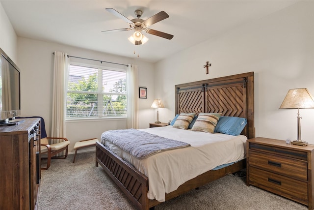 bedroom with light carpet, ceiling fan, and baseboards
