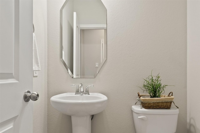 bathroom with toilet and a sink