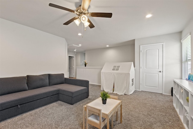 carpeted living room with attic access, a ceiling fan, recessed lighting, and baseboards