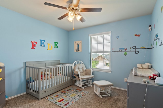 carpeted bedroom featuring a ceiling fan, baseboards, and a nursery area