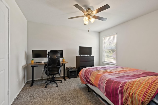 carpeted bedroom with a desk, ceiling fan, and baseboards