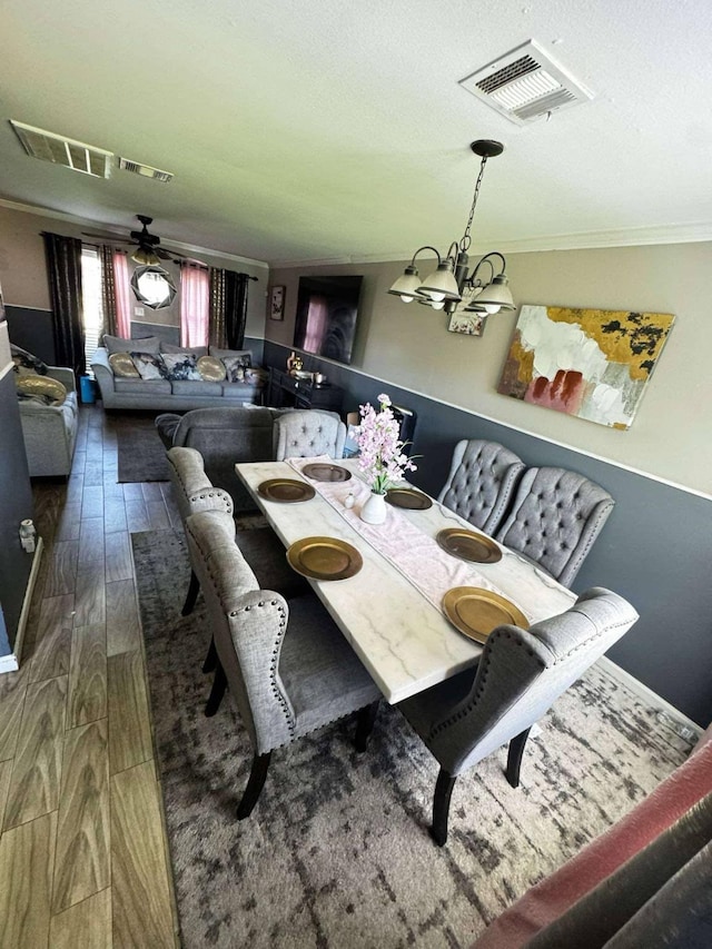 8206 Claiborne St, Houston, TX 77078 - dining space with wood finished floors, a ceiling fan, ornamental molding, and a chandelier