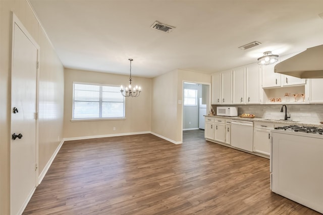 6738 Underhill St, Houston, TX 77092 - kitchen featuring white appliances, open shelves, white cabinetry, backsplash, and wood finished floors