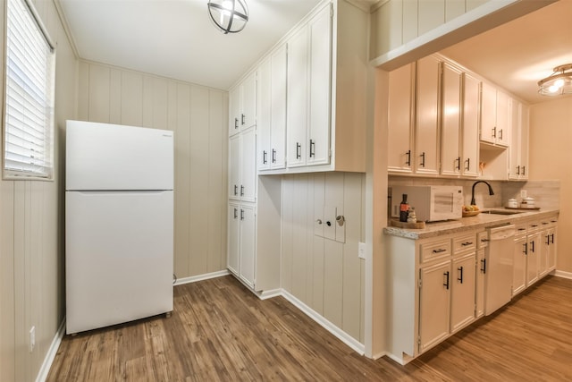 6738 Underhill St, Houston, TX 77092 - kitchen with white appliances, a sink, wood finished floors, and baseboards