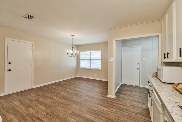 6738 Underhill St, Houston, TX 77092 - unfurnished dining area with a chandelier, dark wood-style flooring, and baseboards
