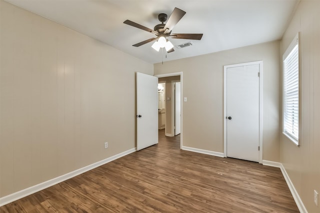 6738 Underhill St, Houston, TX 77092 - unfurnished bedroom featuring wood finished floors, multiple windows, and baseboards