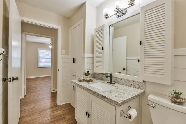 6738 Underhill St, Houston, TX 77092 - bathroom with toilet, wood finished floors, vanity, and baseboards