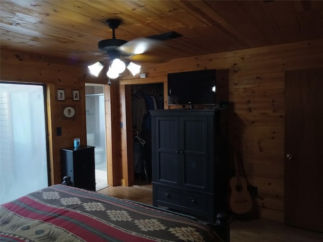 21825 Raven Tree Ct, Porter, TX 77365 - bedroom with wood walls, wood ceiling, a closet, and ceiling fan