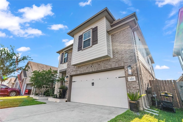 8811 Sandhill Crane Rd, Baytown, TX 77521 - view of front of home featuring brick siding, an attached garage, driveway, and fence