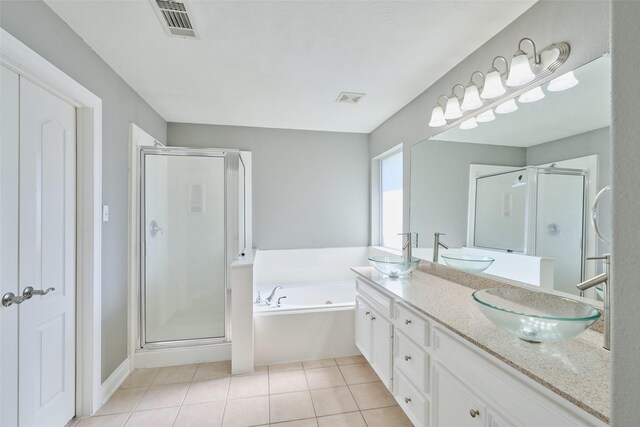 13313 Enchanted Way Dr, Montgomery, TX 77356 - bathroom featuring a stall shower, a garden tub, tile patterned flooring, and double vanity