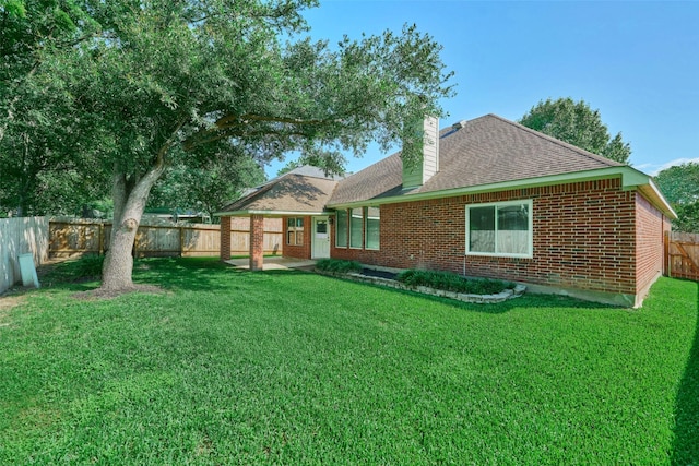 13313 Enchanted Way Dr, Montgomery, TX 77356 - back of property with a chimney, brick siding, and roof with shingles