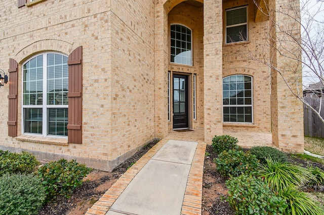 view of exterior entry with brick siding