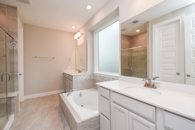 bathroom featuring a stall shower, two vanities, a bath, baseboards, and recessed lighting