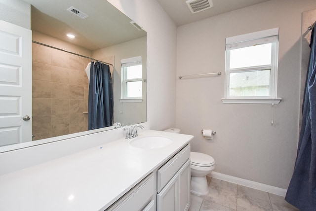 bathroom with toilet, baseboards, vanity, and curtained shower