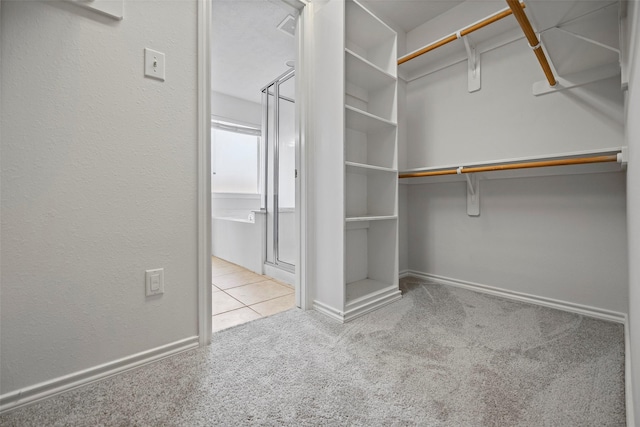 spacious closet featuring carpet flooring and tile patterned flooring