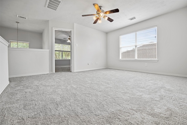 unfurnished room featuring a ceiling fan, baseboards, and carpet floors