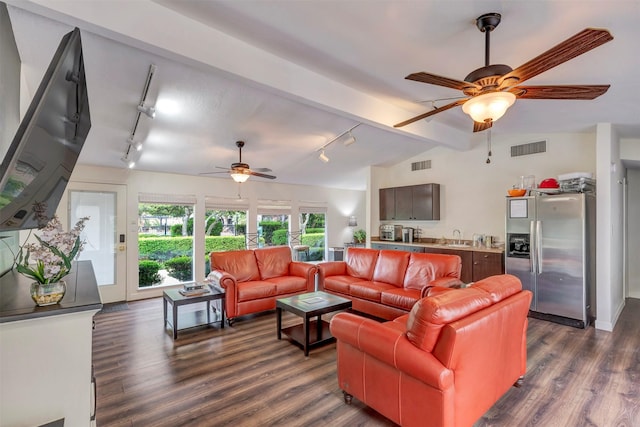 living area featuring rail lighting, a ceiling fan, and dark wood-style floors