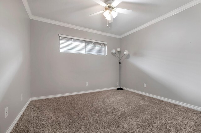 carpeted spare room featuring a ceiling fan, ornamental molding, and baseboards
