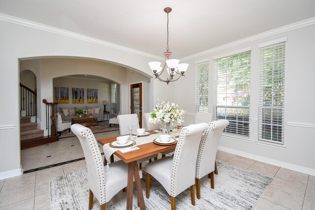 5530 Riverstone Crossing Dr, Sugar Land, TX 77479 - dining area featuring light tile patterned flooring, a chandelier, arched walkways, crown molding, and stairway