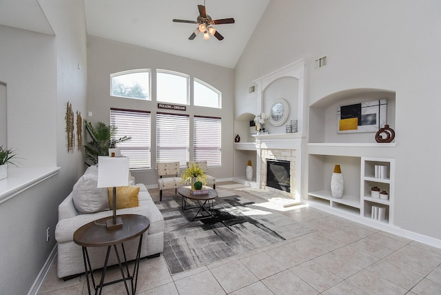 5530 Riverstone Crossing Dr, Sugar Land, TX 77479 - tiled living area featuring built in shelves, a ceiling fan, high vaulted ceiling, a stone fireplace, and baseboards