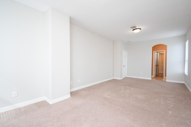 5530 Riverstone Crossing Dr, Sugar Land, TX 77479 - empty room with arched walkways, light carpet, and baseboards