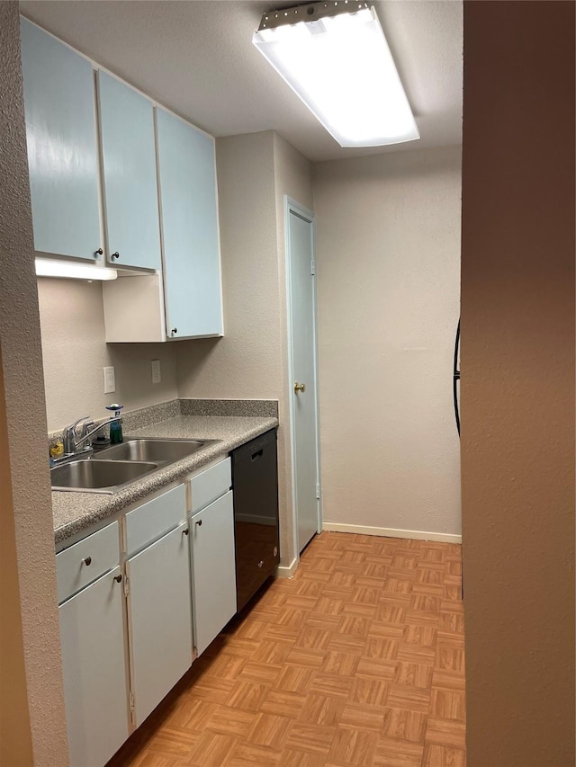 7950 N Stadium Dr Unit 210, Houston, TX 77030 - kitchen with dishwasher, a sink, baseboards, and white cabinetry