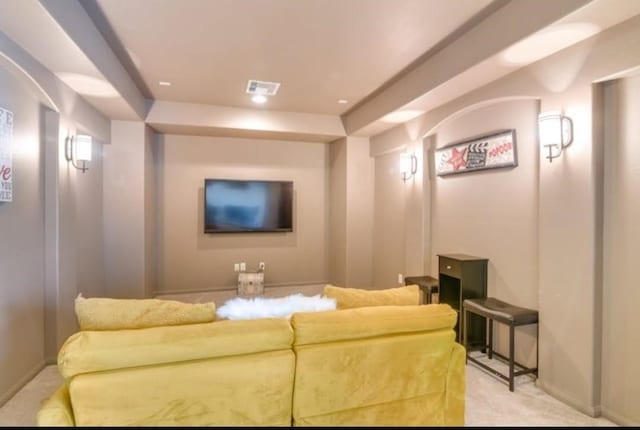 home theater room with light carpet and baseboards