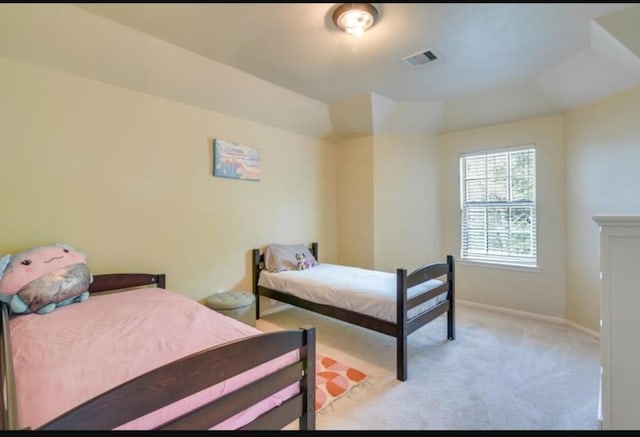 bedroom featuring light colored carpet and baseboards