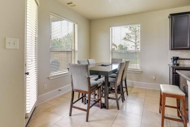 dining room featuring healthy amount of natural light and baseboards