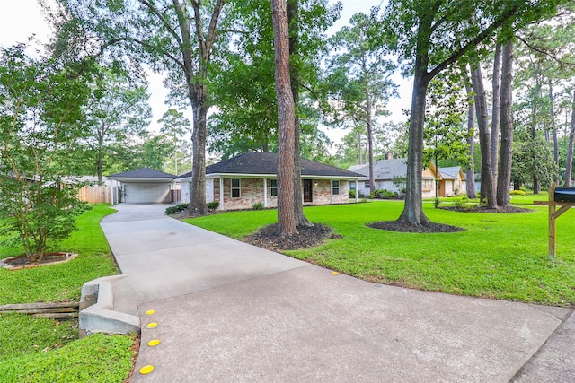 ranch-style house with driveway and a detached garage