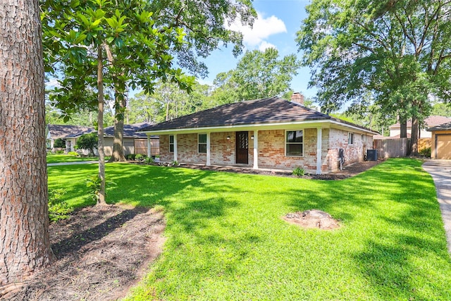 single story home with a chimney, brick siding, and central AC unit