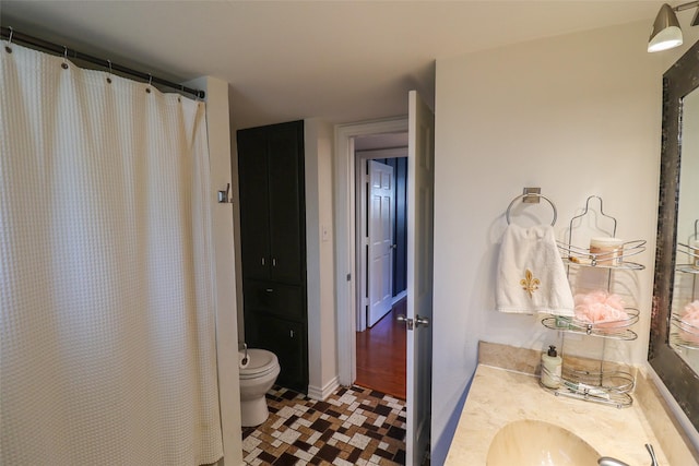 full bathroom with toilet and vanity