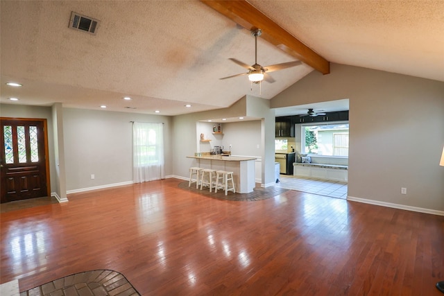 living area featuring a ceiling fan, a textured ceiling, wood finished floors, baseboards, and recessed lighting