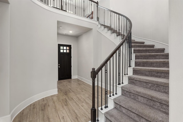 12510 Grayton Dr, Texas City, TX 77568 - foyer entrance with wood finished floors, stairway, baseboards, and a high ceiling