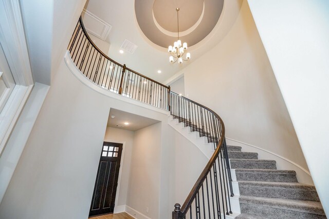 12510 Grayton Dr, Texas City, TX 77568 - stairway with a towering ceiling, a chandelier, and baseboards
