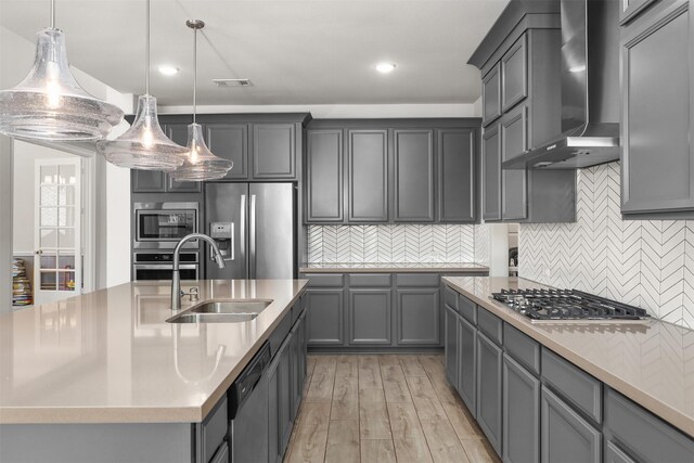 12510 Grayton Dr, Texas City, TX 77568 - kitchen with wall chimney exhaust hood, appliances with stainless steel finishes, a sink, recessed lighting, and light countertops