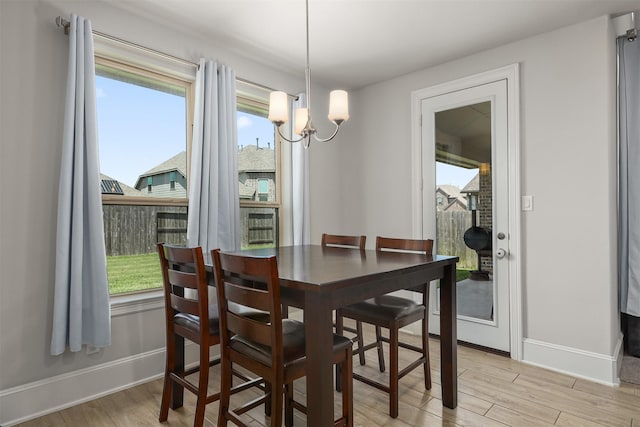 12510 Grayton Dr, Texas City, TX 77568 - dining space with a chandelier, light wood finished floors, and baseboards