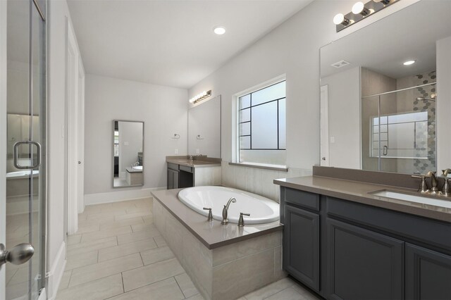 12510 Grayton Dr, Texas City, TX 77568 - full bathroom with a stall shower, a garden tub, tile patterned flooring, two vanities, and recessed lighting