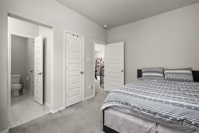 12510 Grayton Dr, Texas City, TX 77568 - carpeted bedroom with baseboards, tile patterned flooring, and connected bathroom