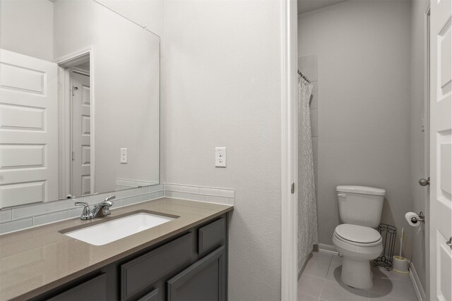 12510 Grayton Dr, Texas City, TX 77568 - bathroom featuring tile patterned floors, toilet, vanity, and baseboards
