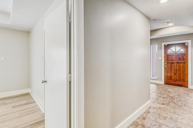 foyer entrance with baseboards and recessed lighting