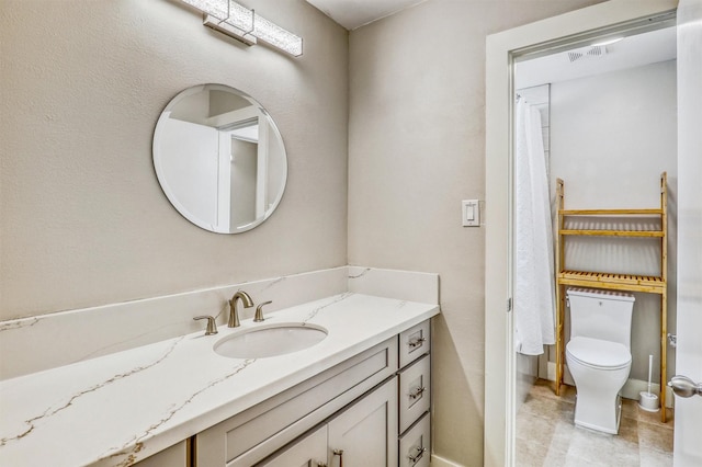 full bath with vanity, toilet, and baseboards