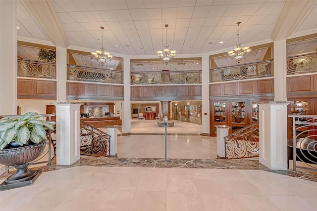 building lobby featuring ornamental molding, a high ceiling, and recessed lighting