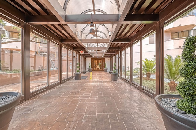 unfurnished sunroom featuring french doors, healthy amount of natural light, and coffered ceiling
