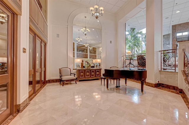 lobby with a high ceiling, recessed lighting, and crown molding