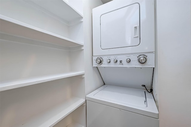 clothes washing area featuring estacked washer and dryer