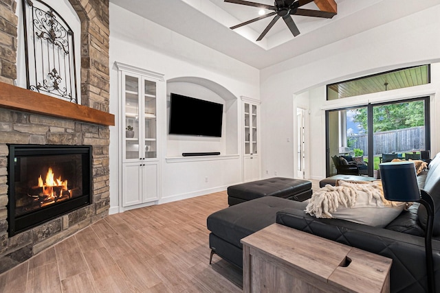 1703 Madera Oaks Ct, Conroe, TX 77304 - living area with a ceiling fan, light wood-style flooring, and a fireplace