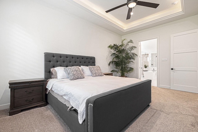 1703 Madera Oaks Ct, Conroe, TX 77304 - bedroom with light colored carpet, a raised ceiling, ensuite bath, and a ceiling fan