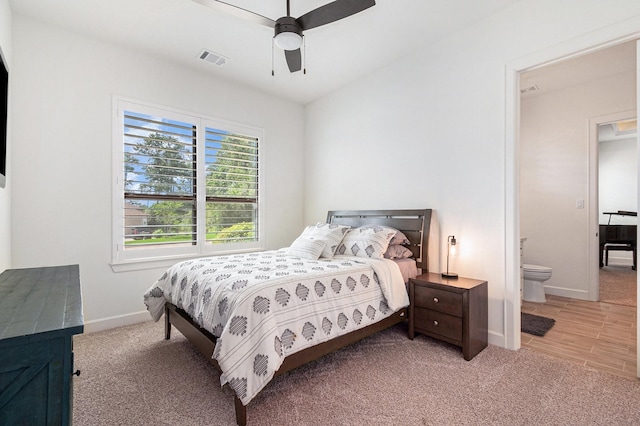 1703 Madera Oaks Ct, Conroe, TX 77304 - bedroom with light colored carpet, a ceiling fan, and ensuite bath