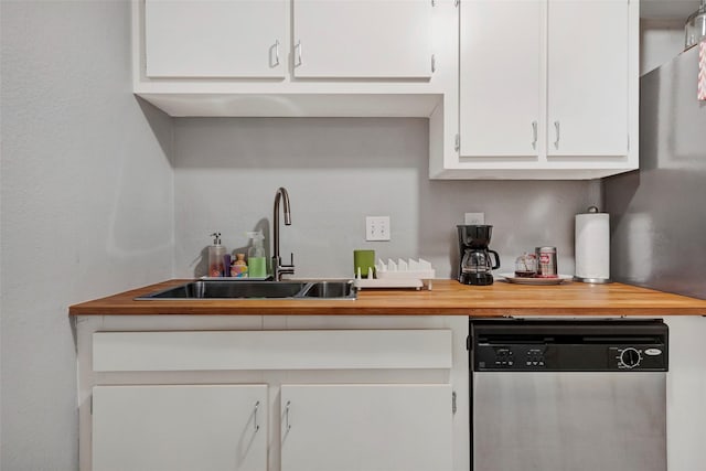 3131 Cummins St Unit 94, Houston, TX 77027 - kitchen with stainless steel dishwasher, white cabinetry, a sink, and butcher block counters